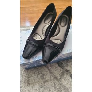 1 1/2" heeled shoe with a fabric upper and cushioned insoles.